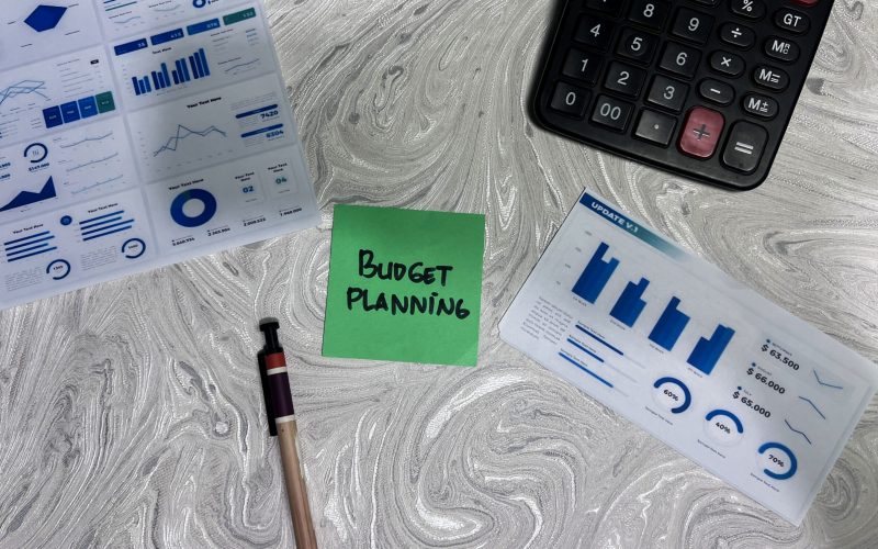 Concept of Budget Planning write on sticky notes isolated on Wooden Table. Concept of Budget Planning write on sticky notes isolated on Wooden Table.
